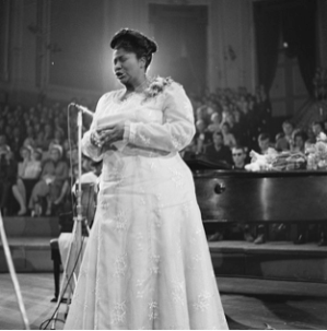 a woman singing in a concert hall
