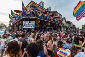 a large crowd of people watching a colorful kite